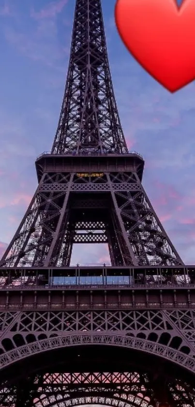 Eiffel Tower with red heart over evening sky.