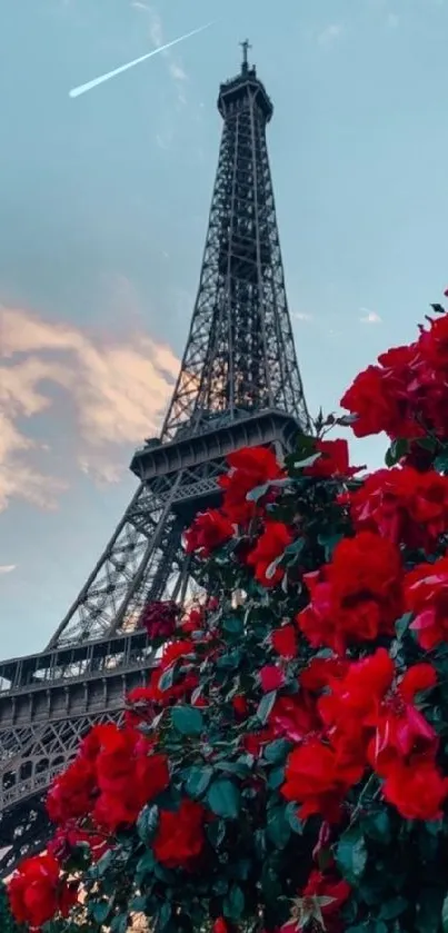 Eiffel Tower with red flowers and blue sky.