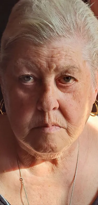 Portrait of an elderly woman in warm sunlight.