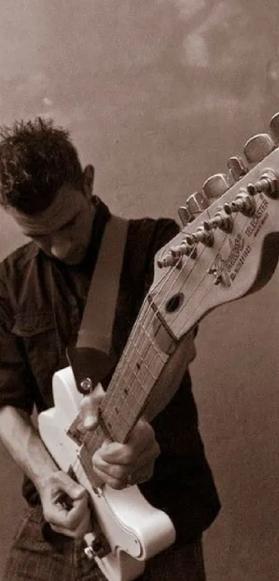 Musician playing electric guitar in sepia-toned photo.