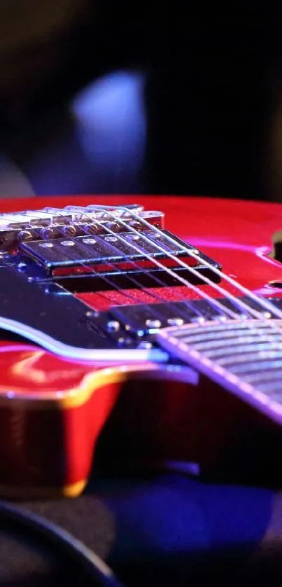 Glossy red electric guitar with chrome detailing on a vibrant background.