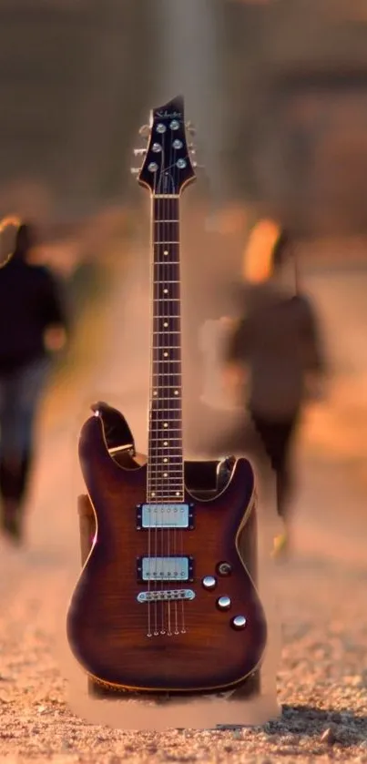 Electric guitar on a path during sunset with blurred figures in the background.