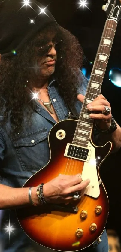 Electric guitarist in denim with starry glow at concert.