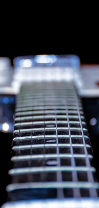 Close-up of electric guitar strings with a black background.