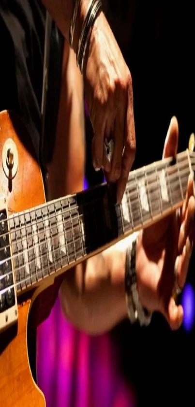 Guitarist strumming electric guitar on stage, vivid lighting.