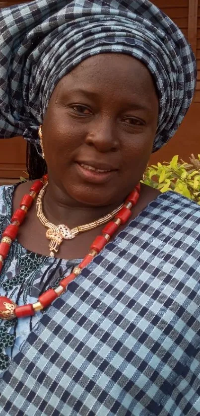 Woman in elegant African attire with bold patterns and colors.