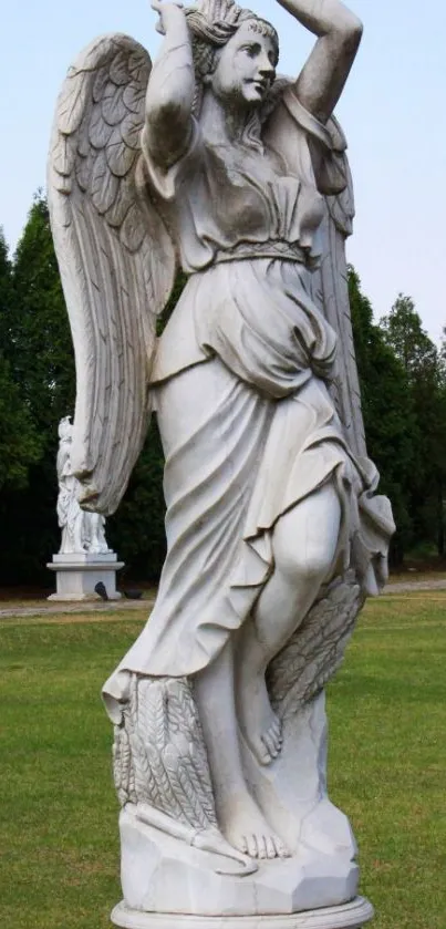 Marble angel statue in tranquil garden setting.