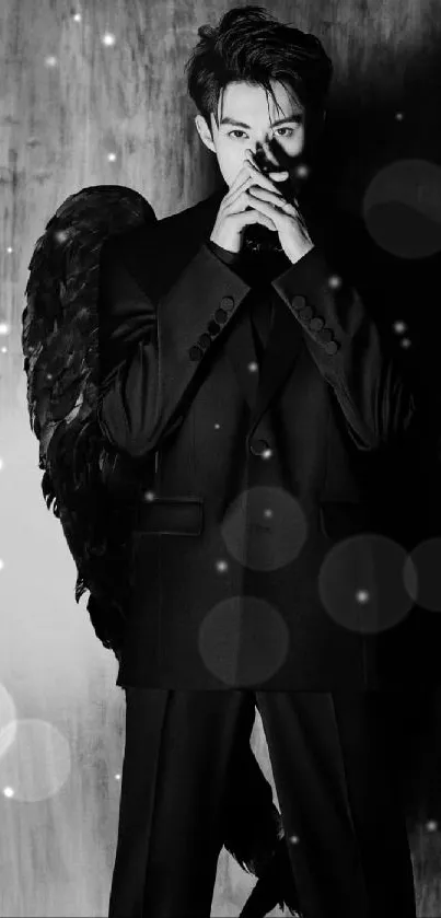 Black and white wallpaper of a figure with dark wings and a suit.