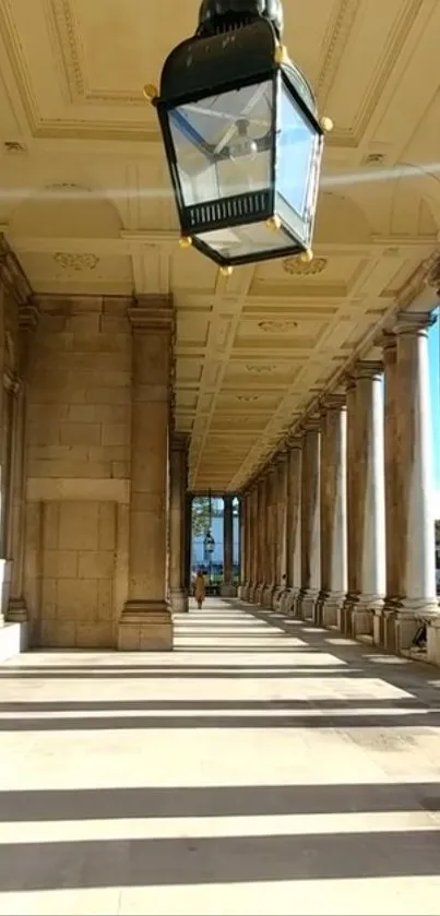 Elegant hallway with columns and ceiling lantern casting shadows.