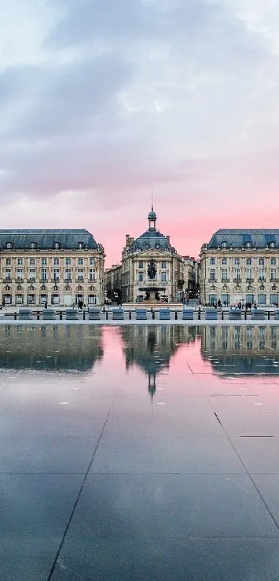 Scenic European building reflecting in water at sunset.