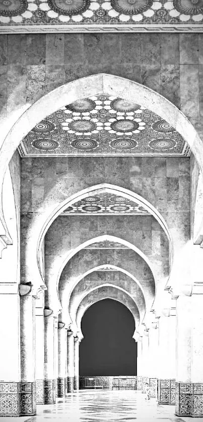 Monochrome photo of elegant archway with intricate ceiling patterns.