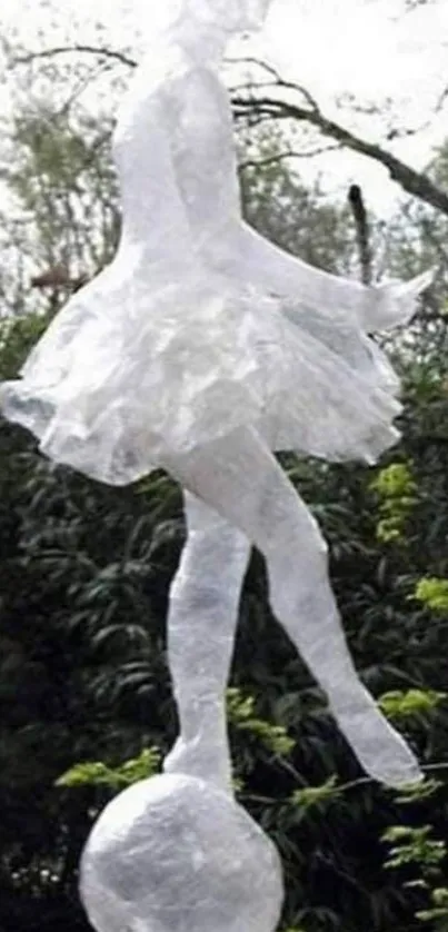 Elegant white ballerina sculpture in outdoor setting.