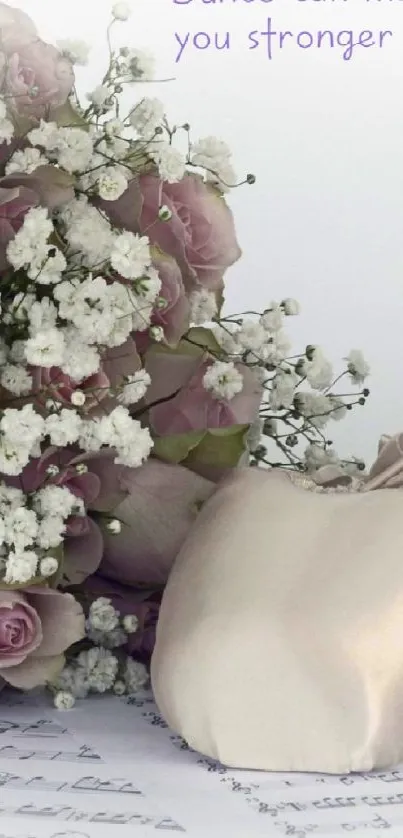 Ballet shoes with a bouquet of roses on a dance-themed wallpaper.