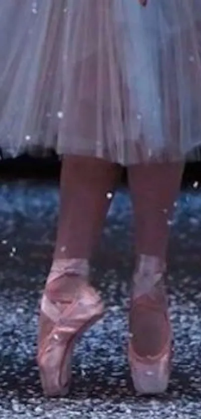 Ballet dancer stands on pointe in snow.