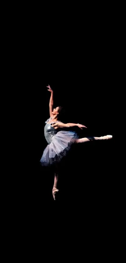 Elegant ballet dancer poised against a dark backdrop.