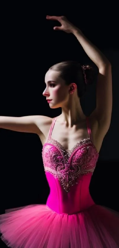 Ballet dancer in pink tutu posing gracefully in studio.