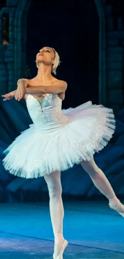 Elegant ballet dancer in white tutu performing on stage.