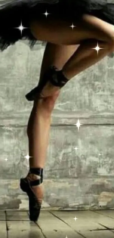 Elegant ballet dancer in pointe pose against a textured gray wall.