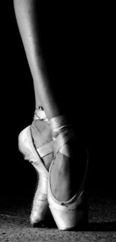 Black and white ballet pose showcasing elegant pointe shoes.