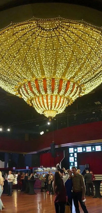 Luxurious gold chandelier in a grand ballroom setting.