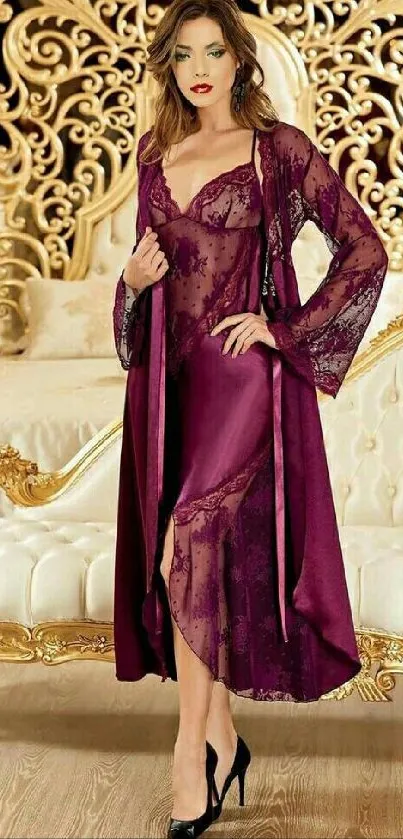 Model in burgundy lace dress in an opulent bedroom setting.