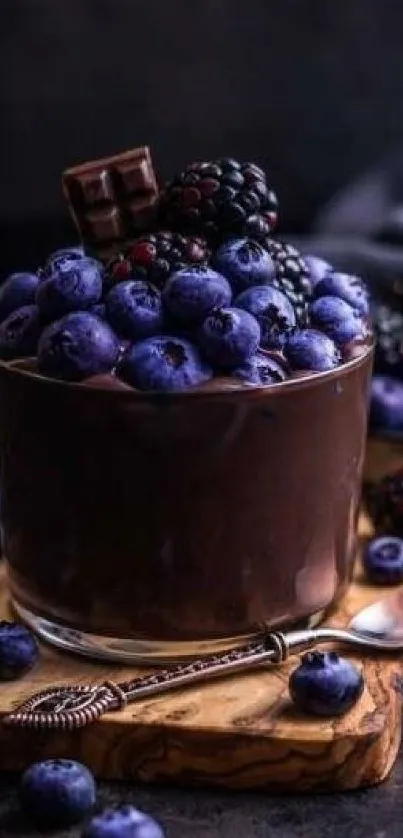 Blueberries and blackberries with chocolate in a dark, elegant arrangement.