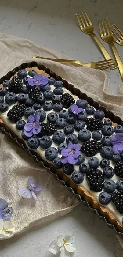 Elegant berry tart with purple flowers.