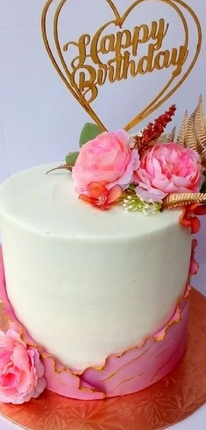 Elegant pink and white birthday cake with floral decorations and gold topper.