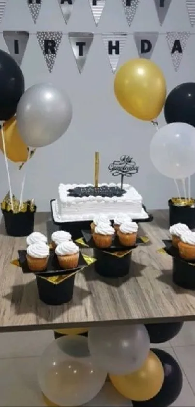 Elegant birthday celebration setup with cake and decorative balloons on a table.