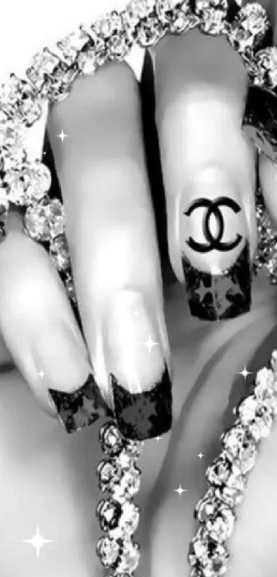 Black and white nails and diamond bracelet on a mobile wallpaper.