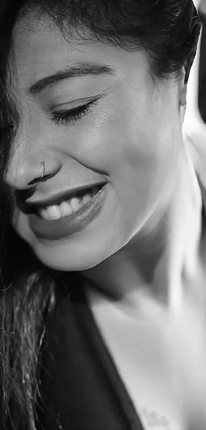 Black and white portrait of a smiling woman.