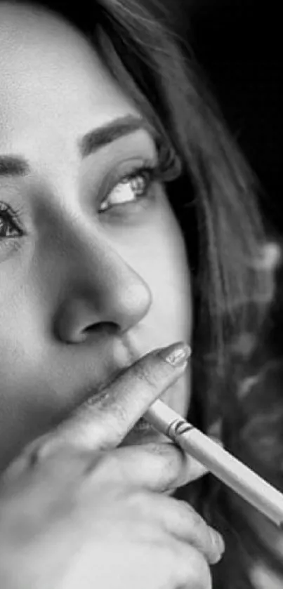 Black and white portrait of a woman smoking, showcasing sophistication and style.