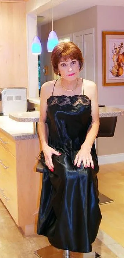 Elegant woman in black dress in a cozy kitchen setting.