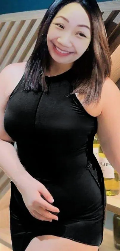 Smiling woman in elegant black dress portrait.