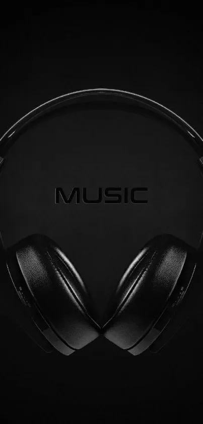 Minimalist black headphones mobile wallpaper featuring music theme.