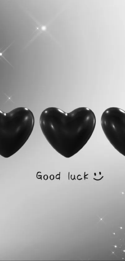 Elegant black hearts wallpaper with good luck message.