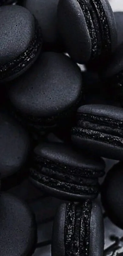 A collection of elegant dark black macarons arranged in artistic fashion.