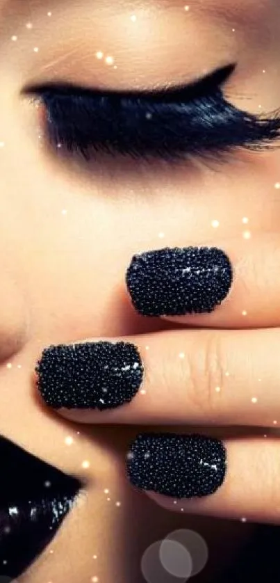 Close-up of elegant black makeup and nail art.