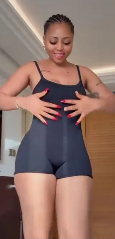 Woman in sleek black outfit indoors.