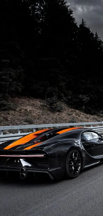 Black sports car with orange stripes on the road.