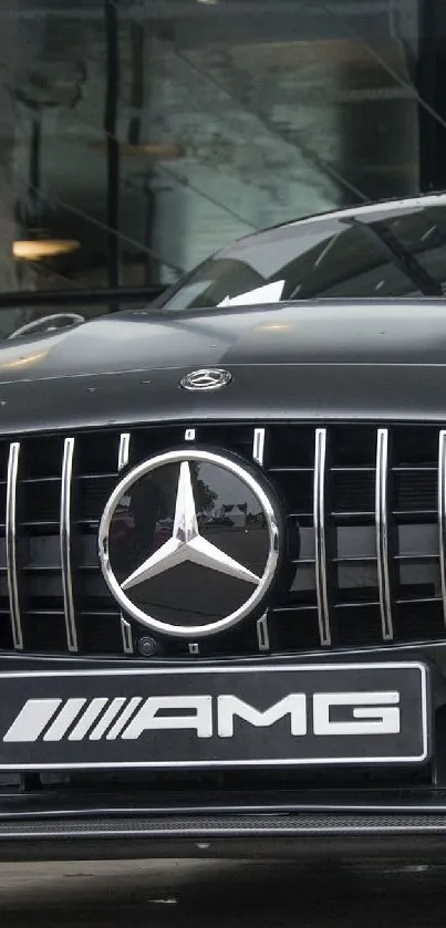 Black sports car front view with sleek AMG design.