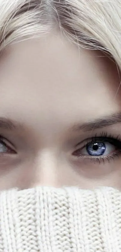 Close-up of a blonde person with soulful blue eyes.