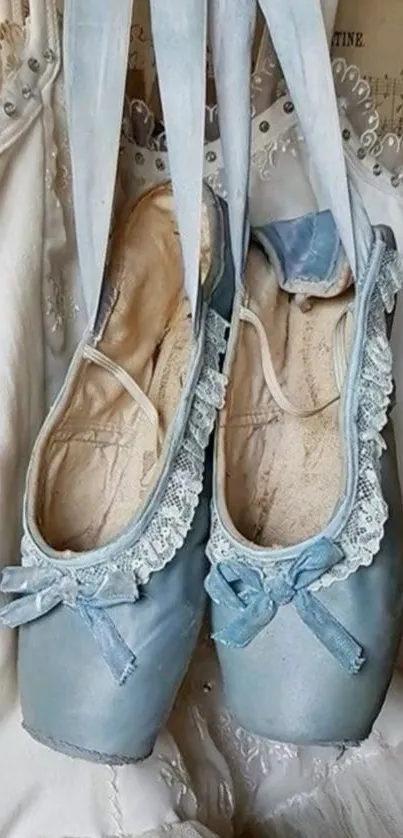 Elegant blue ballet slippers with lace detail hanging gracefully.
