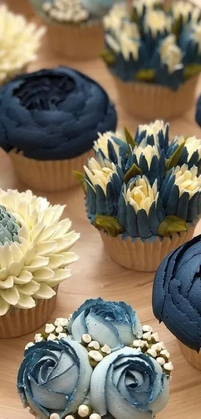 Blue and cream floral cupcakes on wood tray.