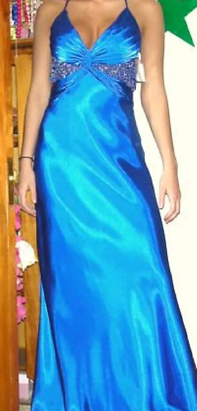 Woman in a vibrant blue evening gown, stylish and elegant.