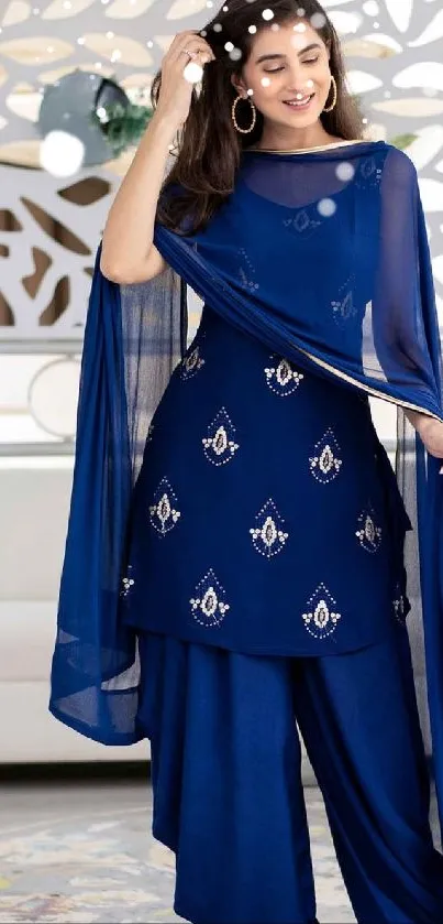 Woman in elegant blue ethnic dress with intricate designs.