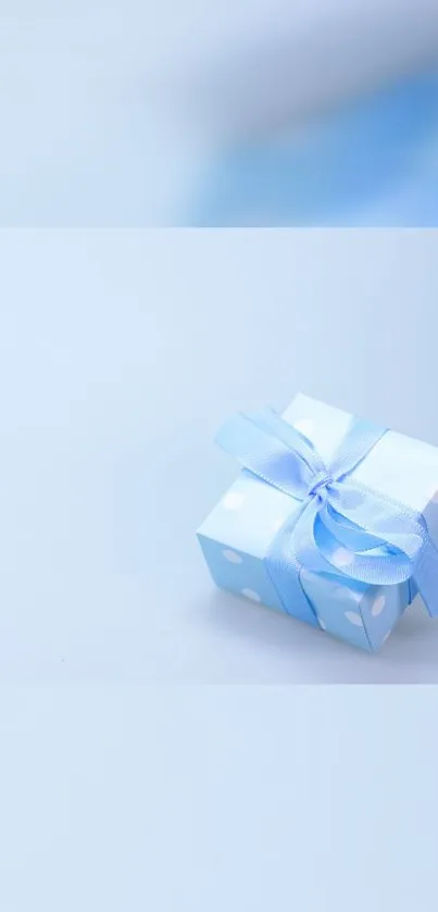 Light blue gift box with ribbon on minimal background.