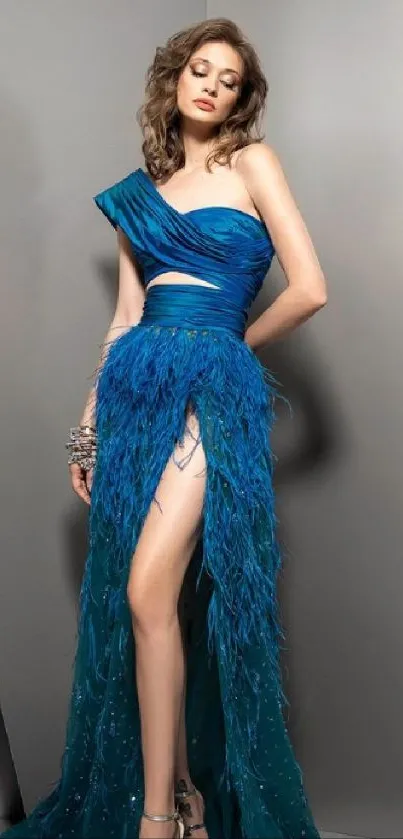 Woman wearing stunning blue gown in elegant pose on wallpaper.