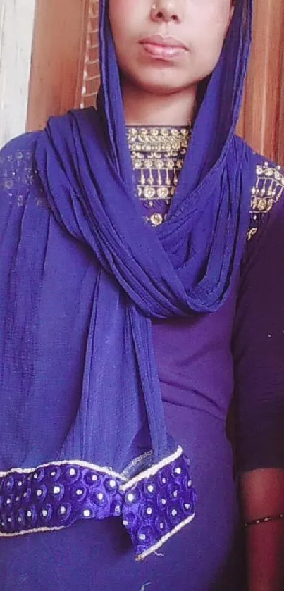 Woman wearing elegant blue hijab with detailed design.