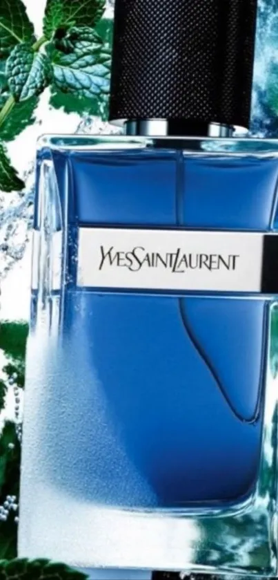 Elegant blue perfume bottle with green leaves backdrop.